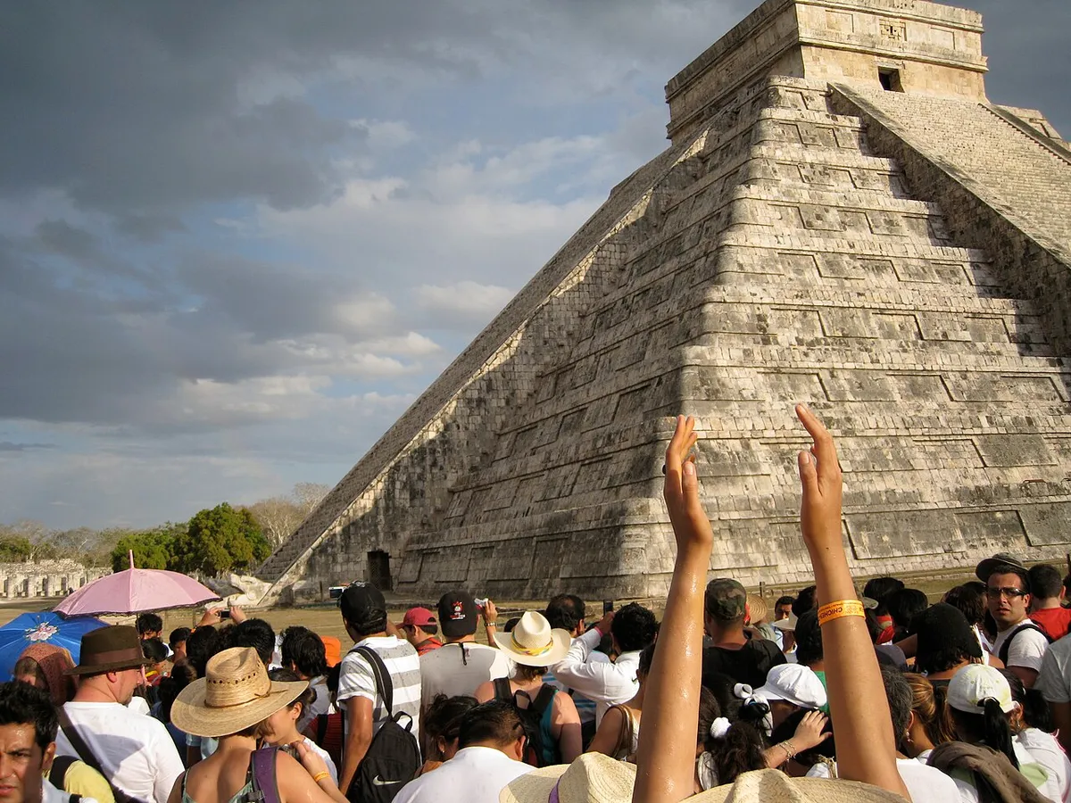 Serpent head sculpture at El Castillo tied to the equinox best time to visit Chichen Itza, Yucatan, Mexico