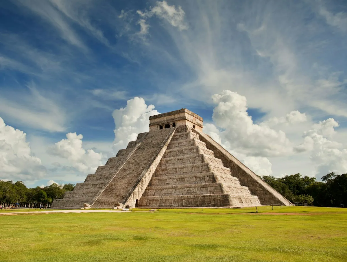 El Castillo pyramid framed by trees on the Chichen Itza grounds entered with a Tiqets entry ticket in Yucatan, Mexico